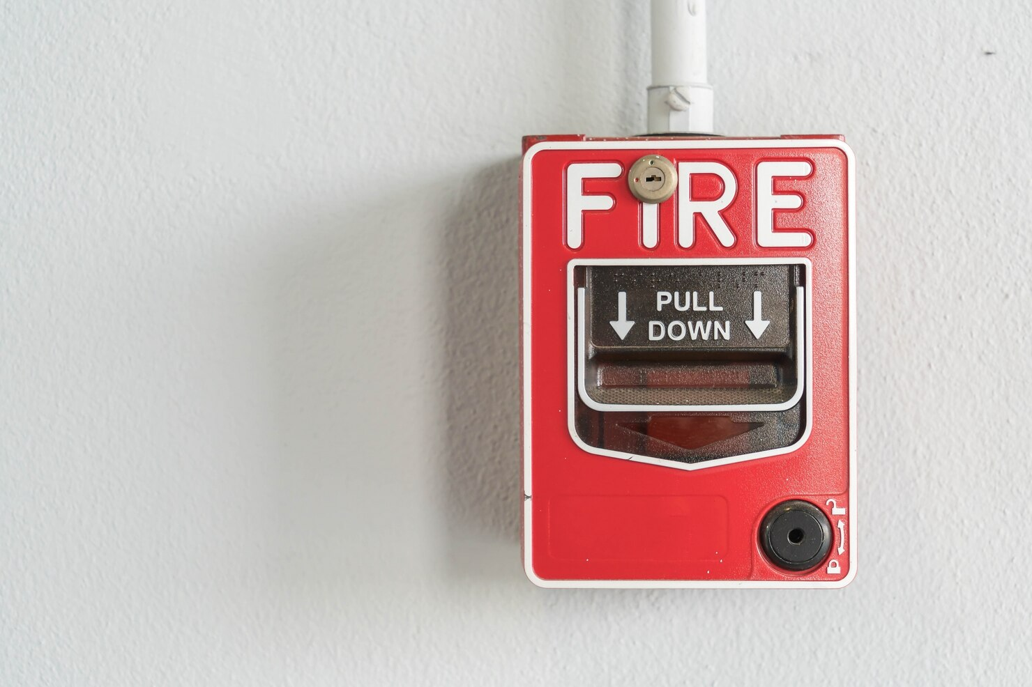 Fire alarm pull station mounted on wall
